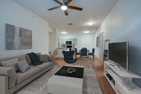 A living room with a grey couch and a white coffee table.