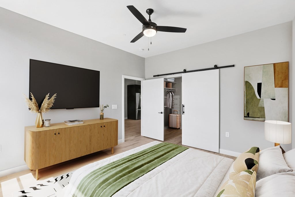 A living room with a green rug and a white couch.