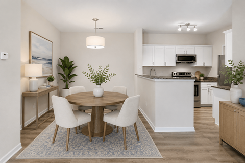 A modern kitchen with a dining table set up with four chairs.