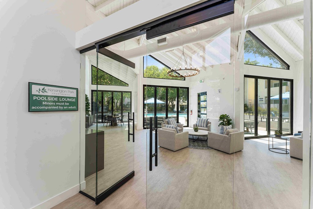 a large open room with a pool in the background and a sign on the wall that says