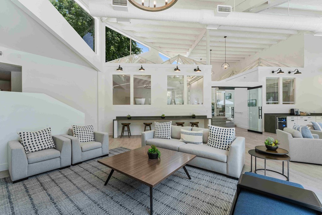 a living room filled with furniture and a large window