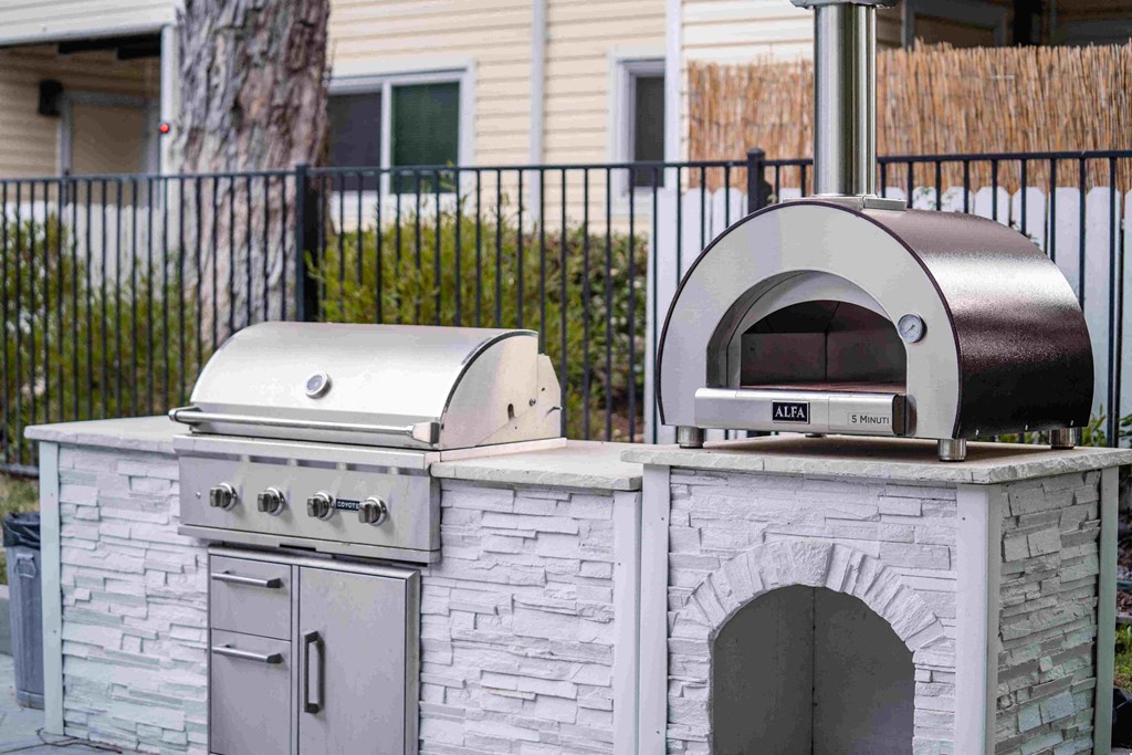 a bbq pit in front of a house