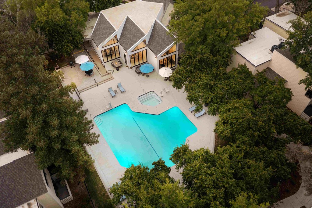 arial view of a swimming pool in front of a house