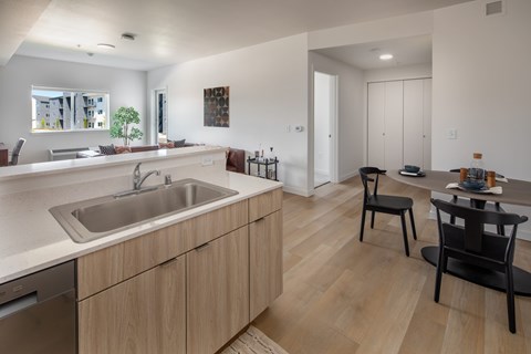 Modern kitchen with wooden cabinets and a white countertop at The Arvon, Vancouver, 98662