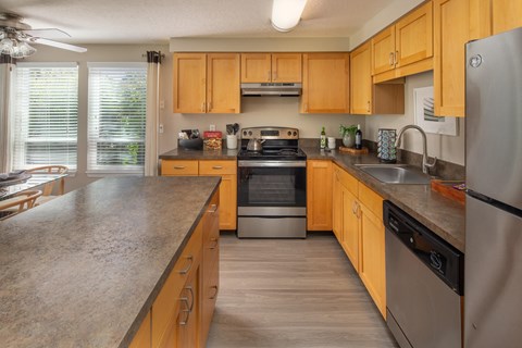 A kitchen with wooden cabinets and stainless steel appliances.