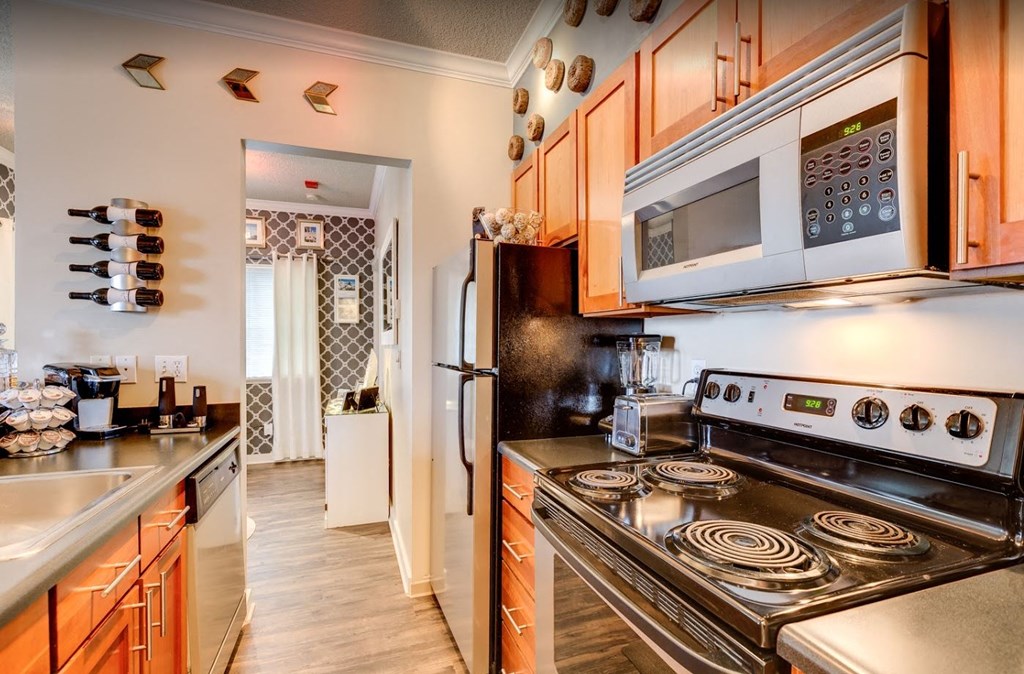 a kitchen with wood cabinets and stainless steel appliances