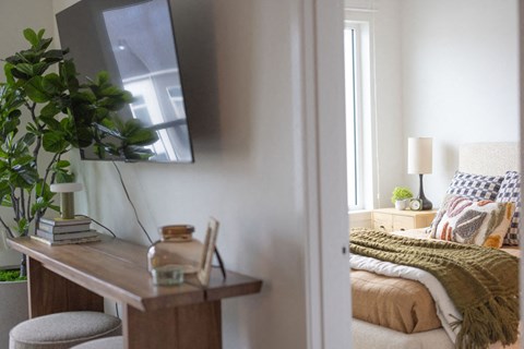 a bedroom with a bed and a desk with a mirror