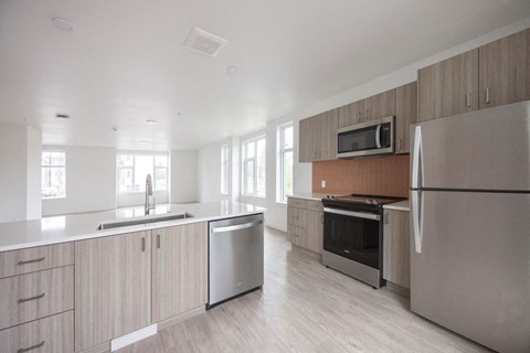 a kitchen with wooden cabinets and stainless steel appliances
