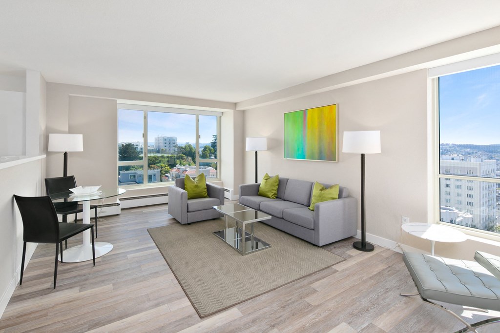 a living room with a gray couch and a glass coffee table