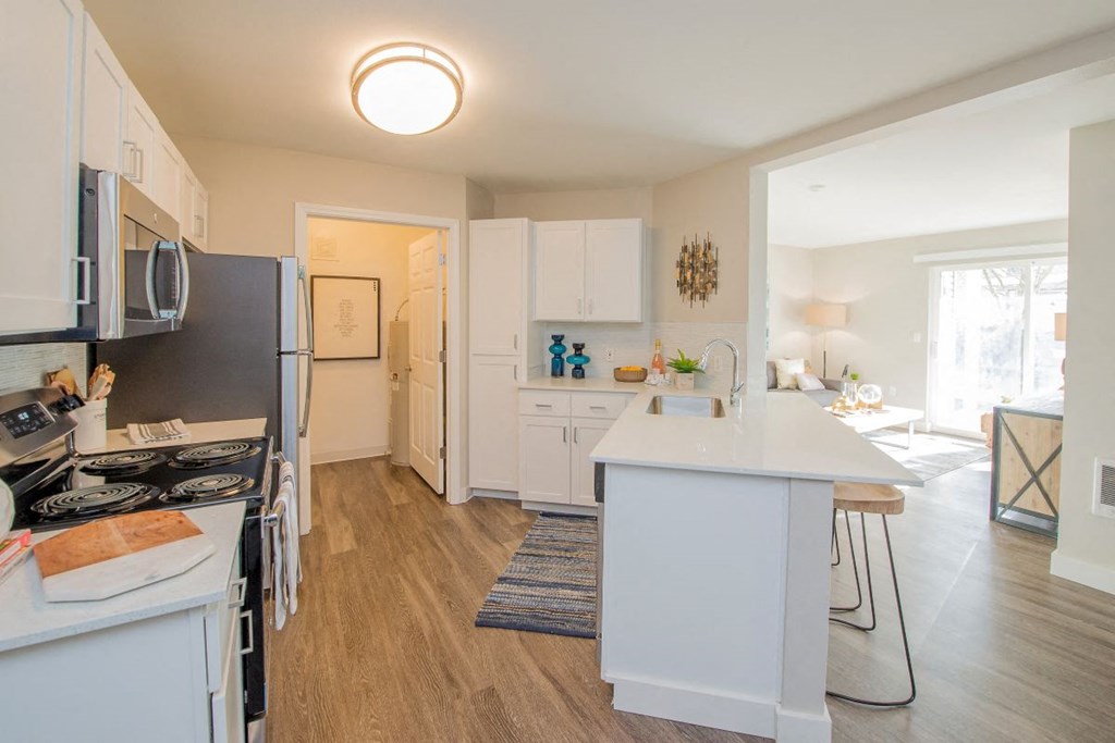 a kitchen with white cabinets and a white counter top at The Arden Apartments, Gresham, 97080