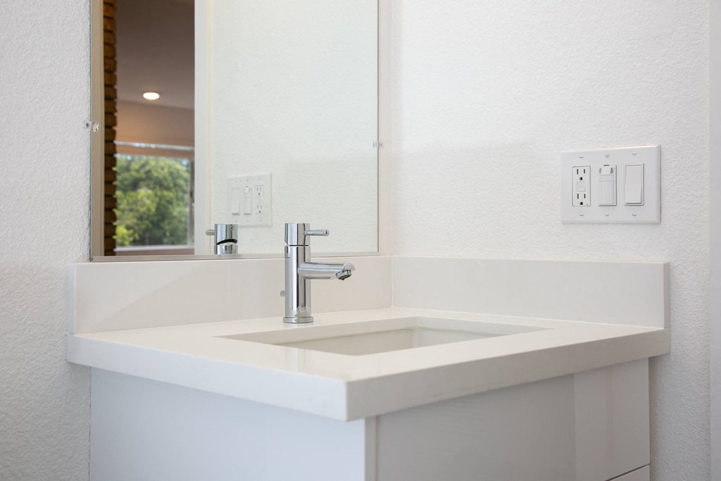 a bathroom with a sink and a mirror