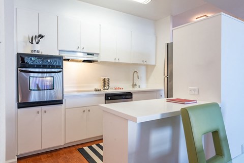 a kitchen with white cabinets and a white counter top