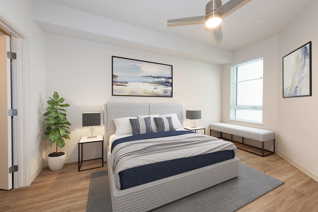 a bedroom with a bed and a ceiling fan