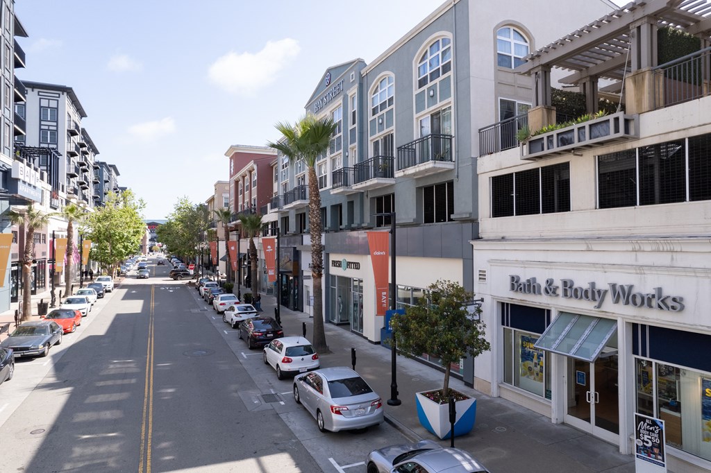 a city street with cars parked on the side of the road