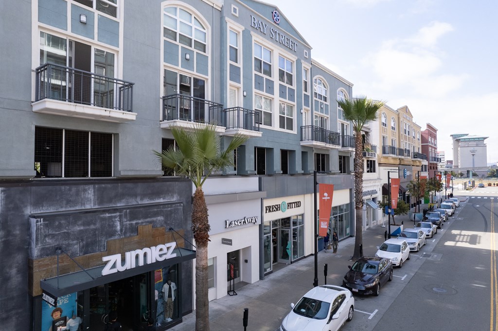 a city street with cars parked on the side of the road