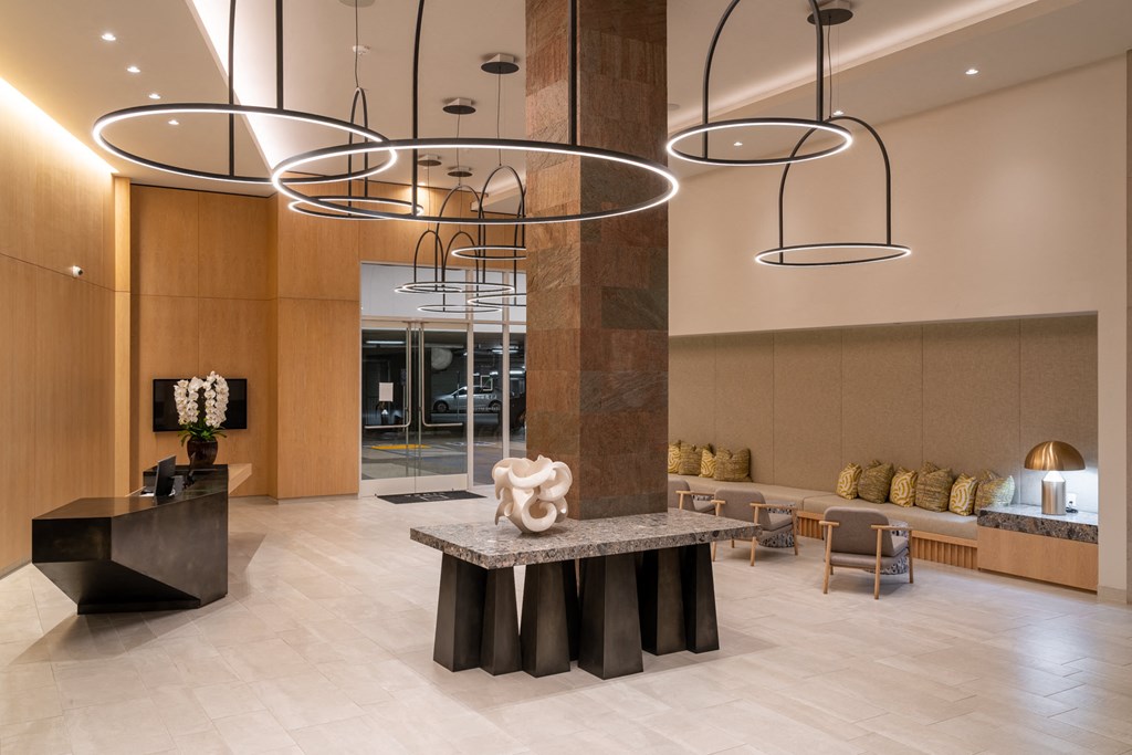 the lobby with a large stone pillar and several lights