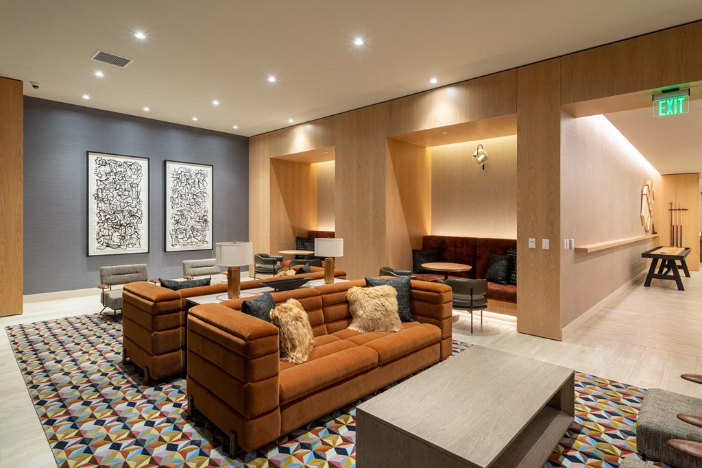 clubroom with couches and chairs and a rug