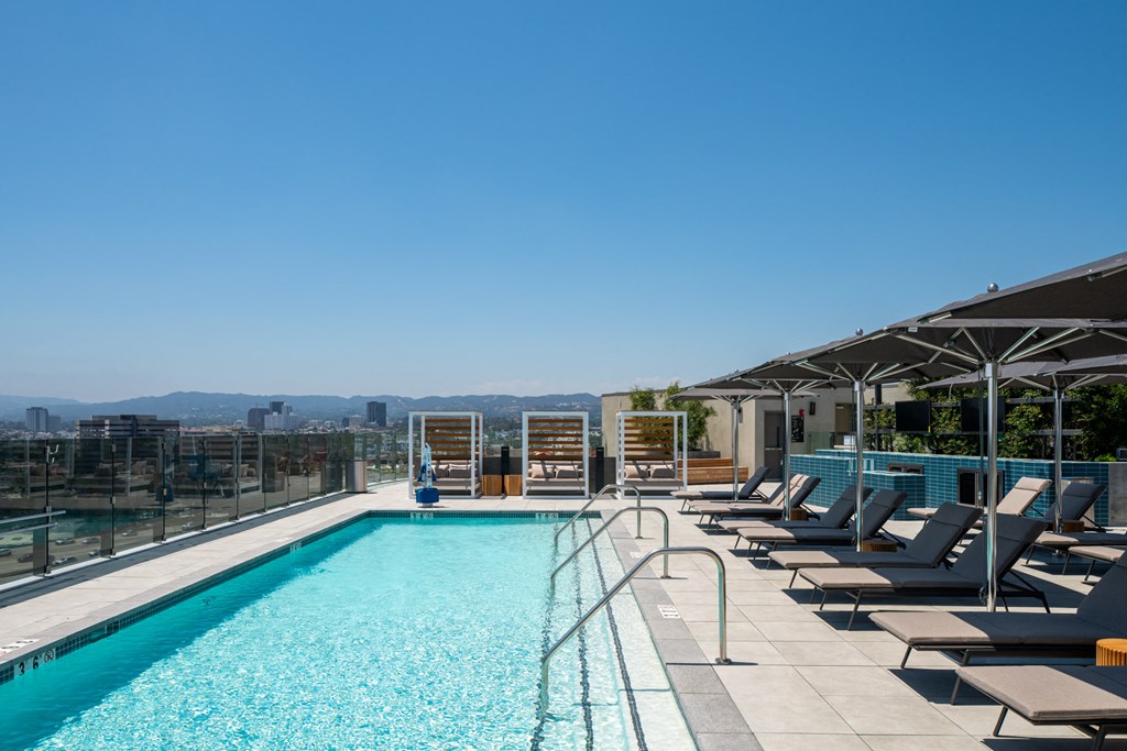 a swimming pool with lounge chairs