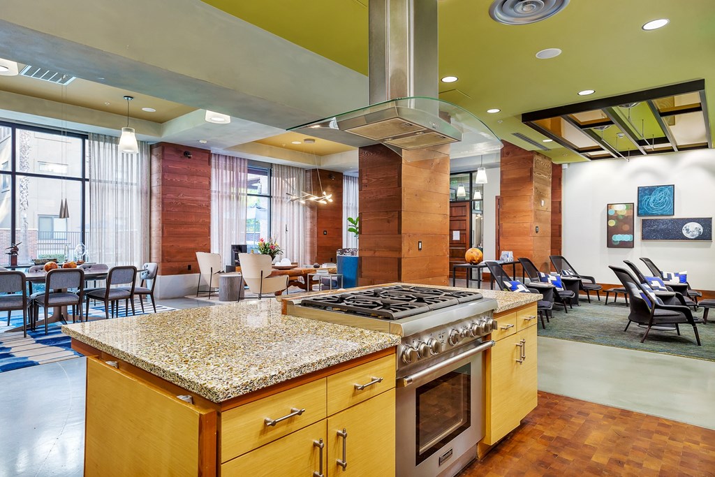 a large kitchen with granite counter tops and a stove top