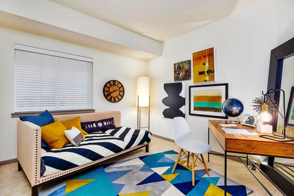a living room with a couch and a desk