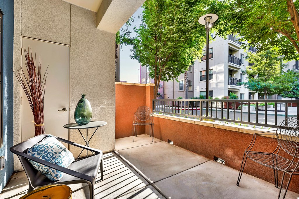 a balcony with a chair and a table