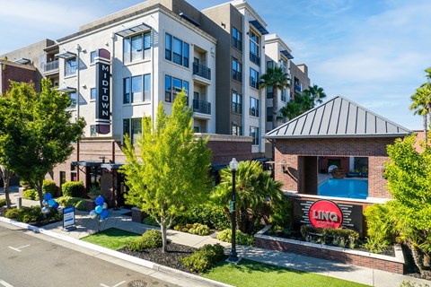 A view of a street with a building that has a sign that says "Midtown" on it.
