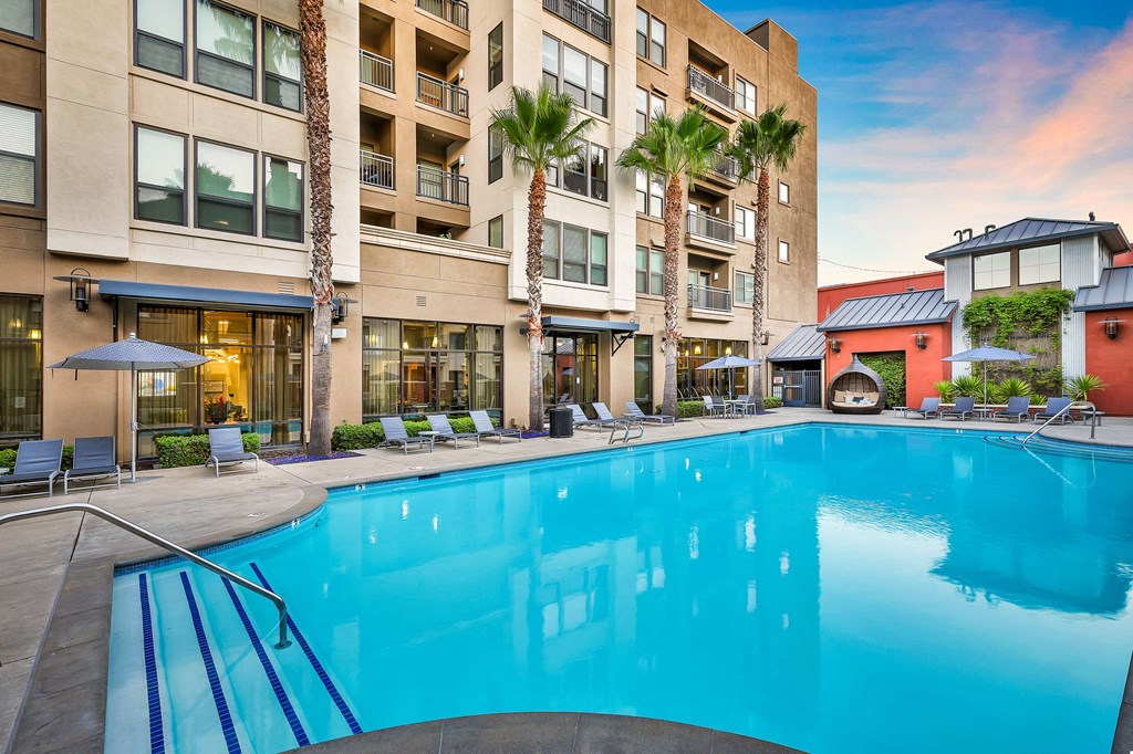 a swimming pool with a large building in the background