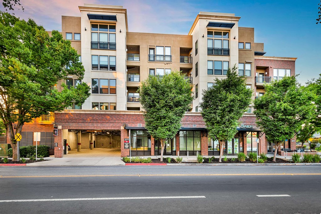 an exterior view of an apartment building on a city street