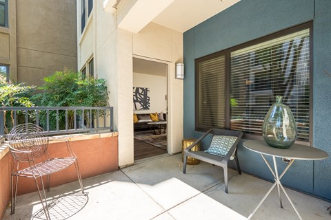 A patio with a table and chairs.