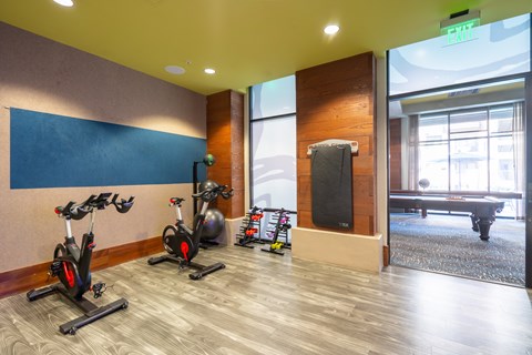 A gym with exercise bikes and a television.