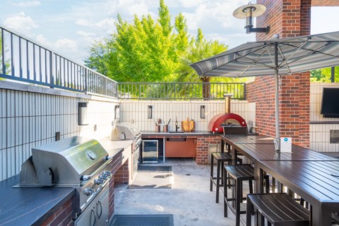 A patio with a grill and bar area.