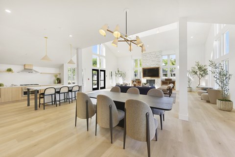 A modern dining room with a large table and chairs.