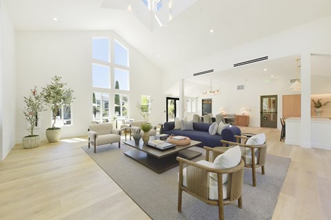 A spacious living room with a large sofa set and a coffee table.