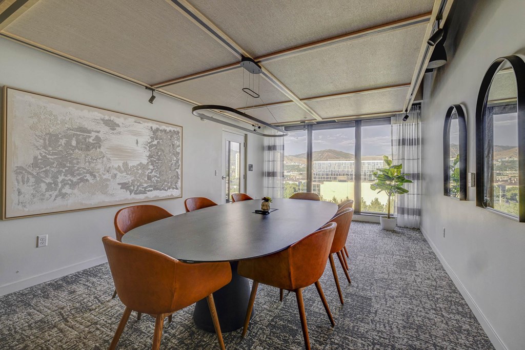 a meeting room with a large table and chairs