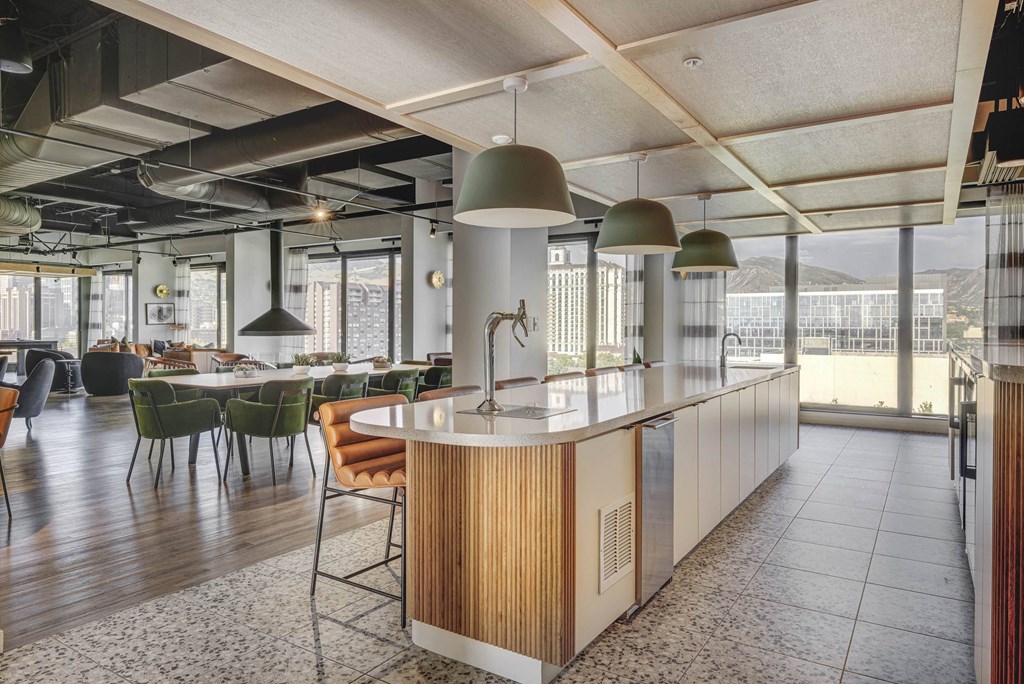 a kitchen with an island and a dining area in the background