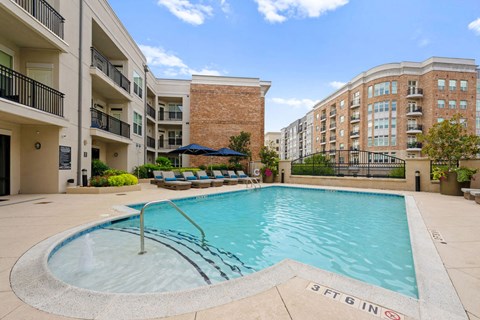 A swimming pool in a residential area with a sign that says "3FT 6 IN".