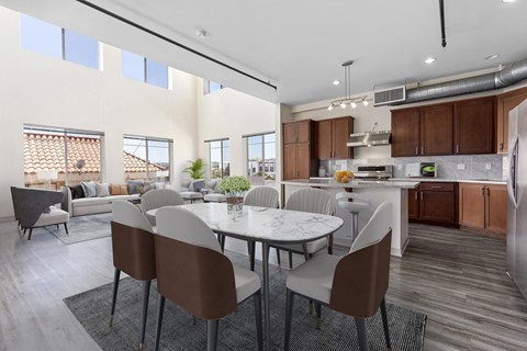A modern kitchen with a dining table and chairs.