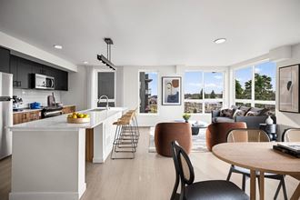 a kitchen and living room with white walls and hardwood floors at Ion Town Center, Shoreline