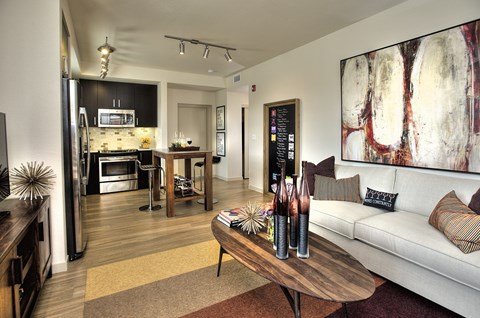 A modern living room with a white couch and a coffee table.