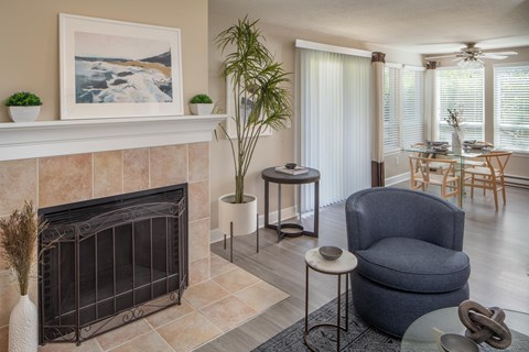 A living room with a fireplace and a painting on the wall.