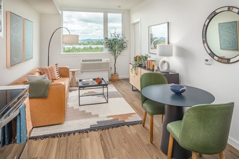 a living room with a couch and a table and a window