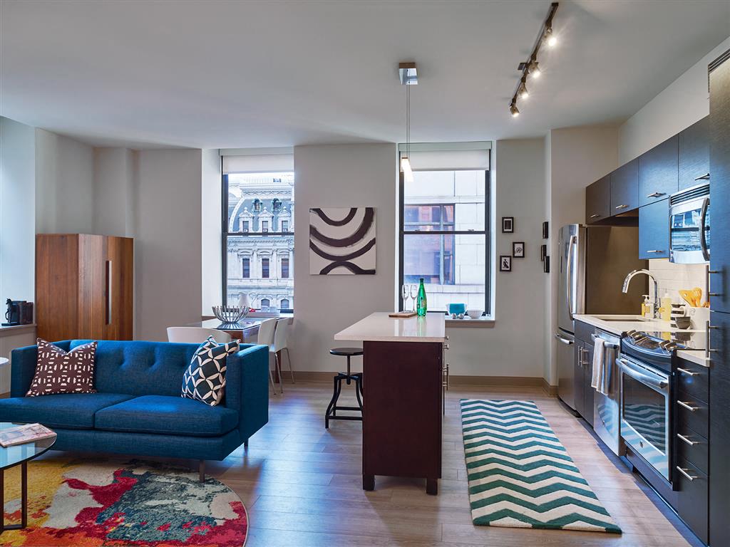 a kitchen and living room with a blue couch