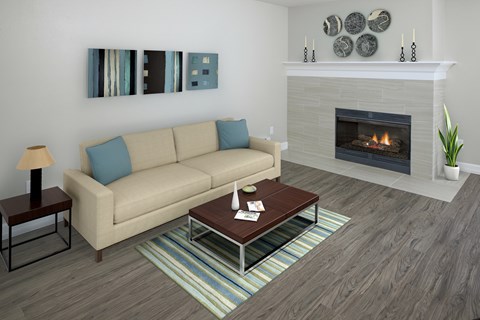 A living room with a beige couch, a fireplace, and a painting on the wall.