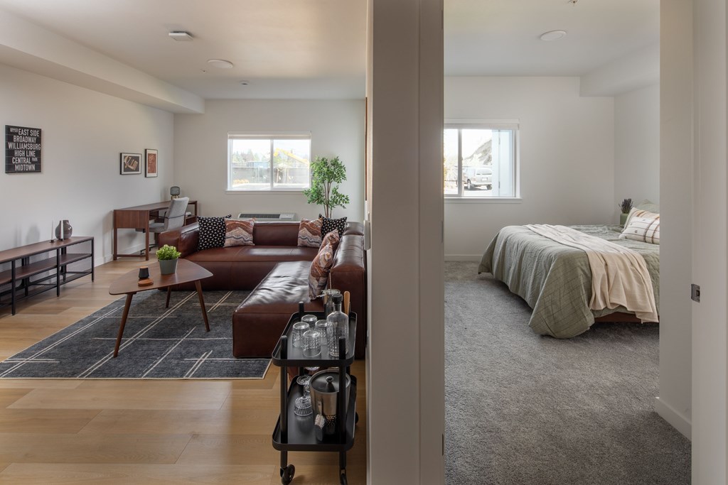 A living room with a brown leather couch and a coffee table.