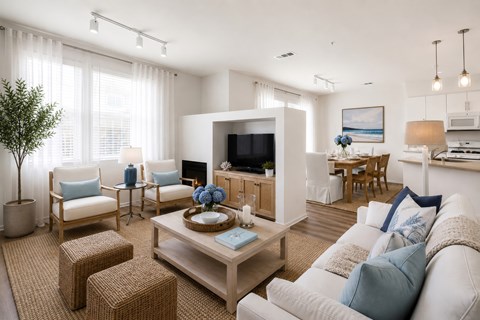 A living room with a white couch and a wooden coffee table.