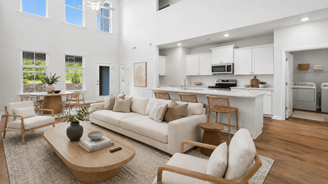A modern living room with a white couch and wooden furniture.