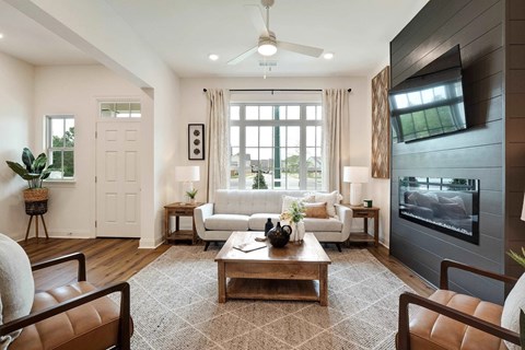 A modern living room with a brown rug and a white sofa.