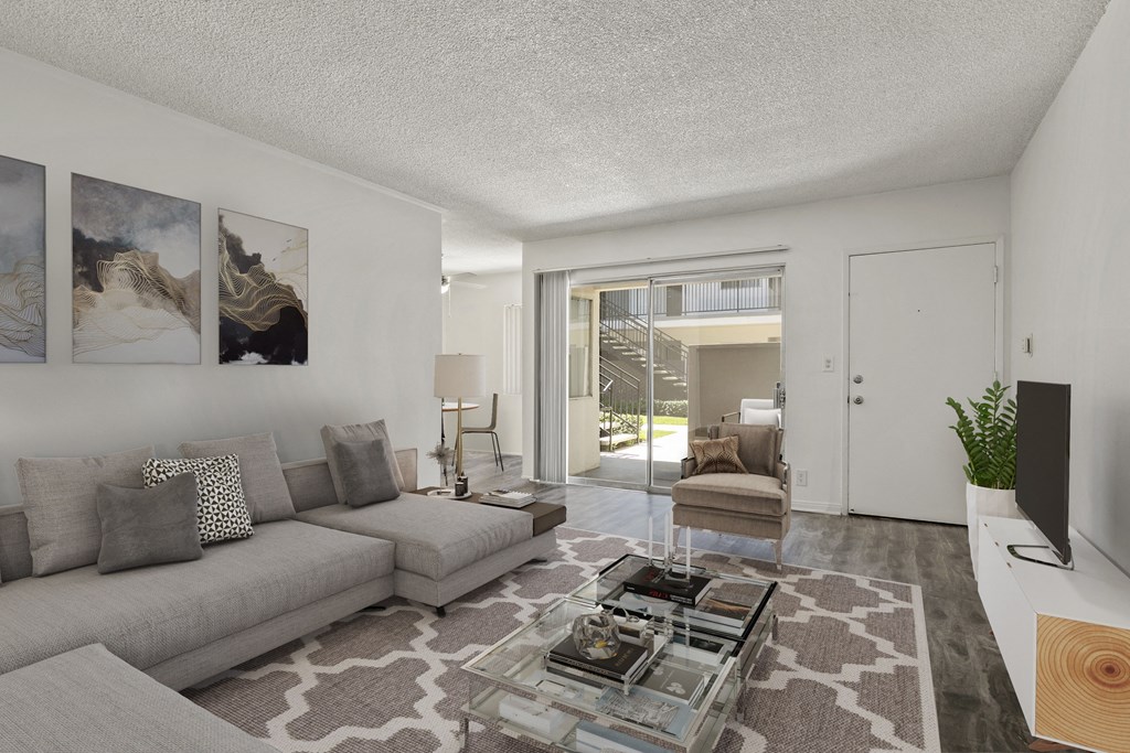 a living room with a couch and a glass coffee table at Pacific Rose, Los Angeles