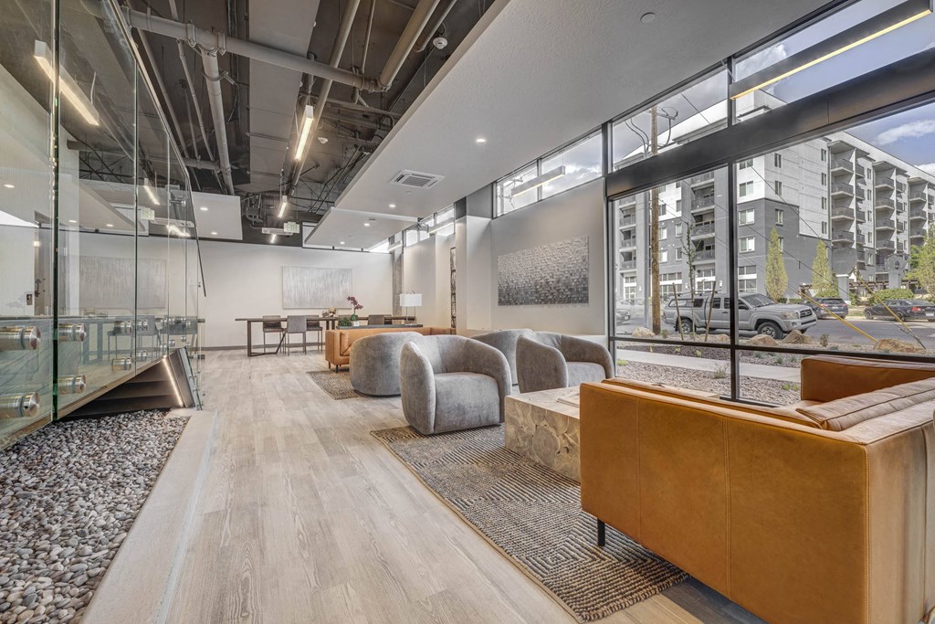 A modern office space with wooden floors and glass walls.