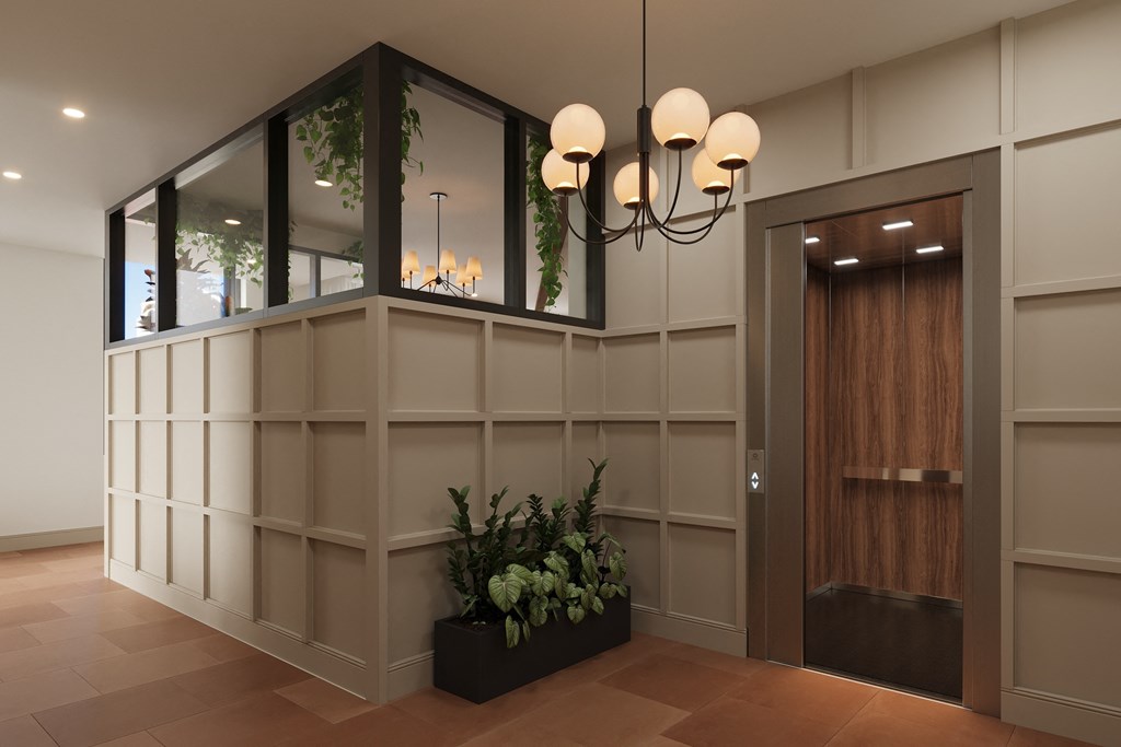 a lobby with a door and a wall with mirrors and a plant